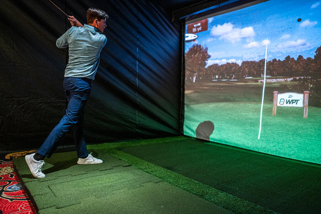 man using a golf simulator